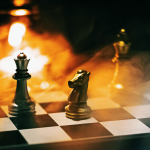 A stylized chess board with orange fire-like lighting in the background